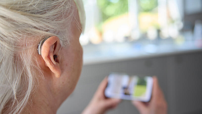 Close Up Of Senior Woman Wearing Behind The Ear Hearing Device O