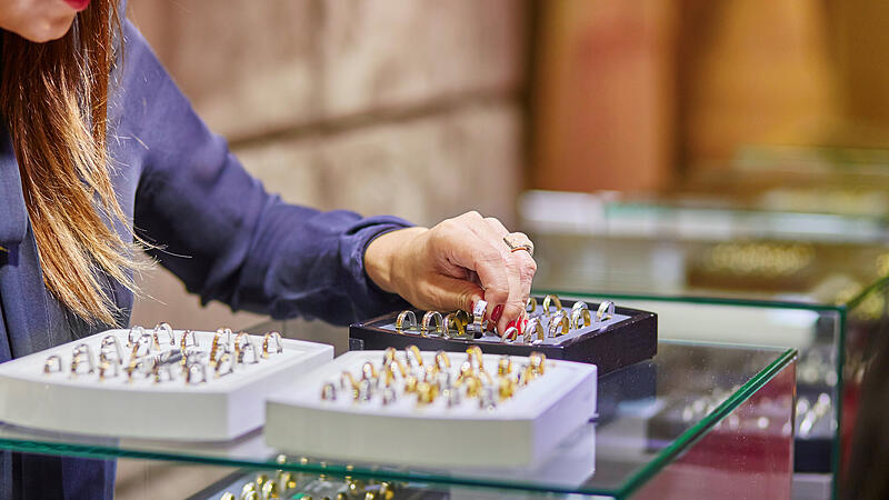 Jeweler helping client to choose wedding ring