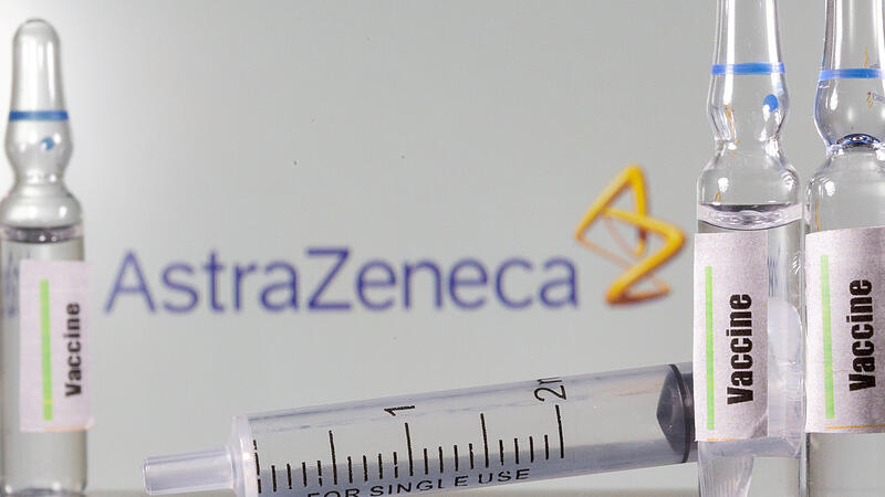 FILE PHOTO: A test tube labelled with the Vaccine is seen in front of an AstraZeneca logo in this illustration