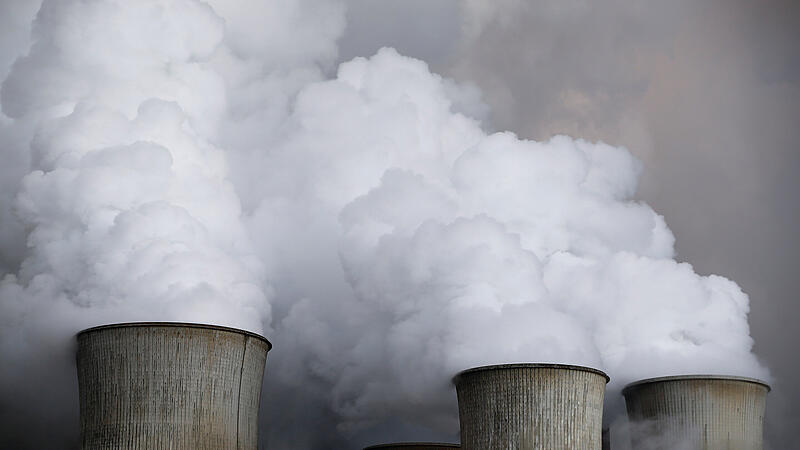 Steam rises from the cooling towers of the coal power plant of RWE in Niederaussem