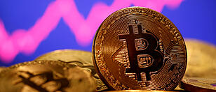 FILE PHOTO: FILE PHOTO: A representation of virtual currency Bitcoin is seen in front of a stock graph in this illustration taken