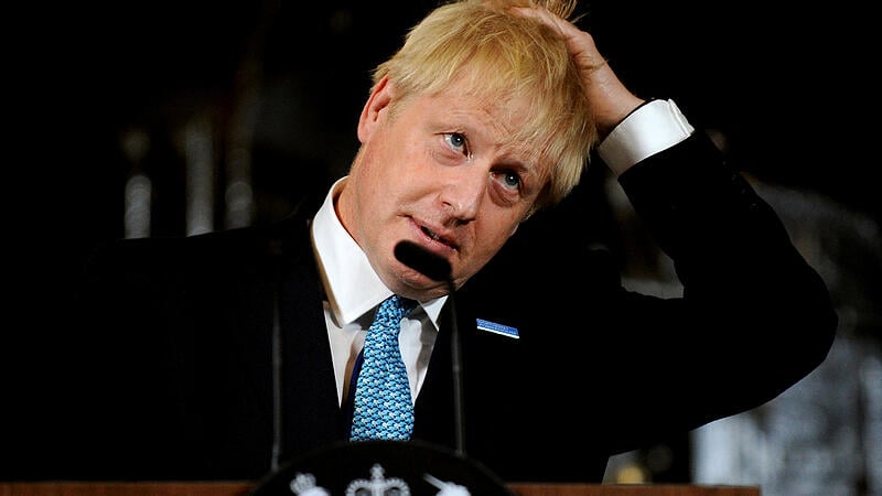 Britain's Prime Minister Boris Johnson touches his hair during a speech on domestic priorities at the Science and Industry Museum in Manchester