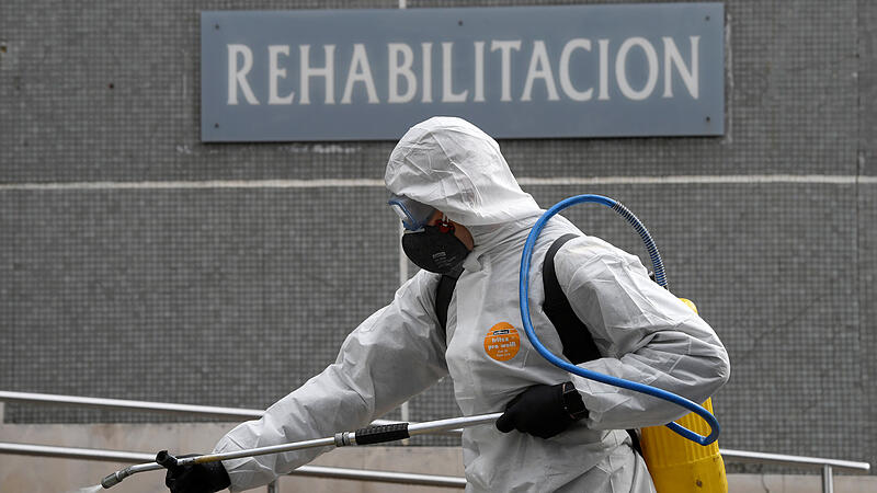 A member of the Military Emergency Unit (UME) sprays disinfectant to prevent the spread of the coronavirus disease (COVID-19) at Cabuenes Hospital in Gijon