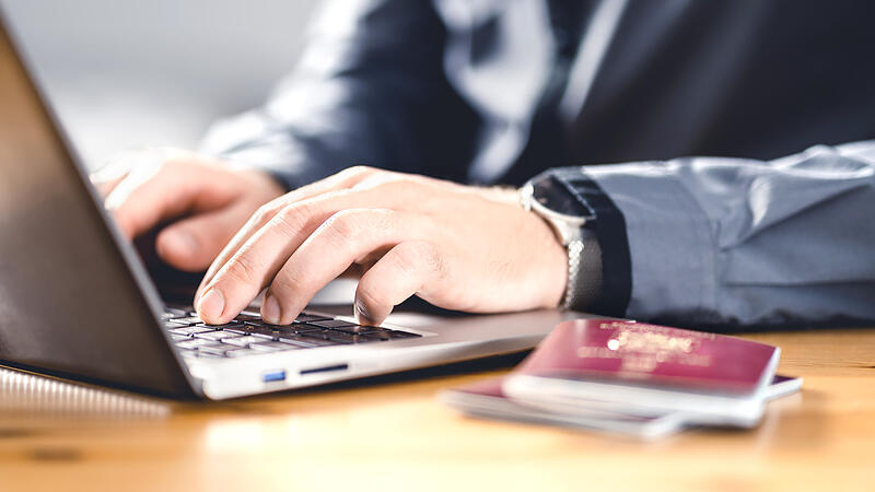 Man with passport and laptop. Travel document and identification