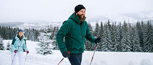 Mature couple cross country skiing outdoors in winter nature, Tatra mountains Slovakia.