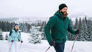 Mature couple cross country skiing outdoors in winter nature, Tatra mountains Slovakia.