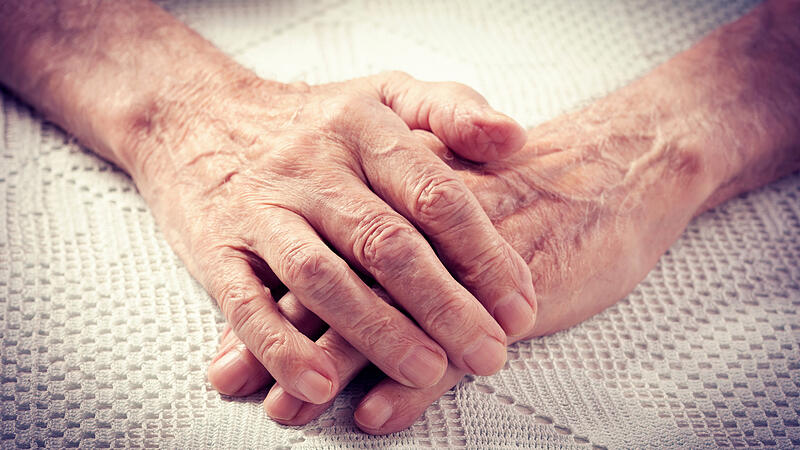 Old people holding hands.