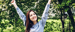 Asia woman standing stretch her arms relax and enjoy with nature