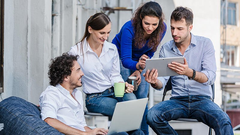 Team of creatives brainstorming at office terrace