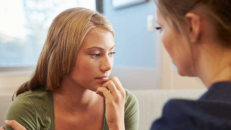 Nurse Treating Teenage Girl Suffering With Depression